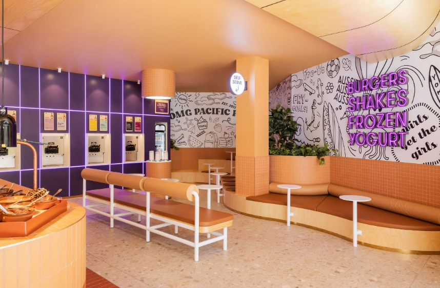 Self-serve yogurt station at YOMG with variety of toppings